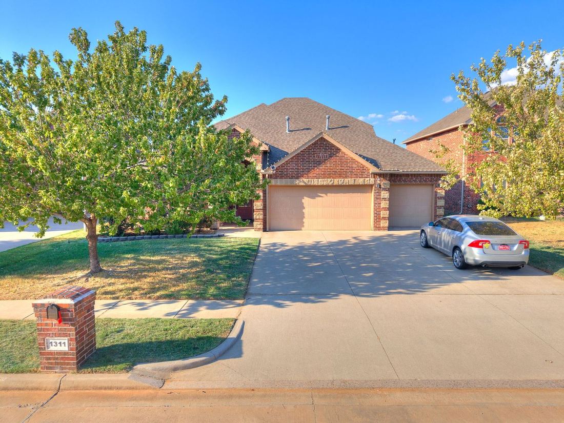 Front of 1311 Skyler Way, a brick and stone home in Norman