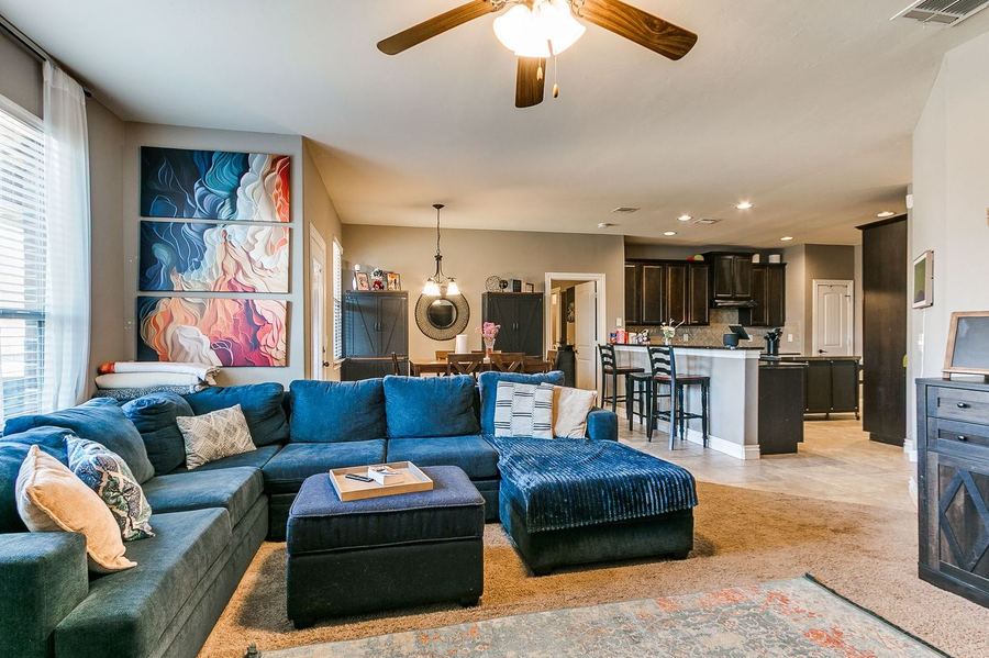 Living room with a fireplace open to the kitchen
