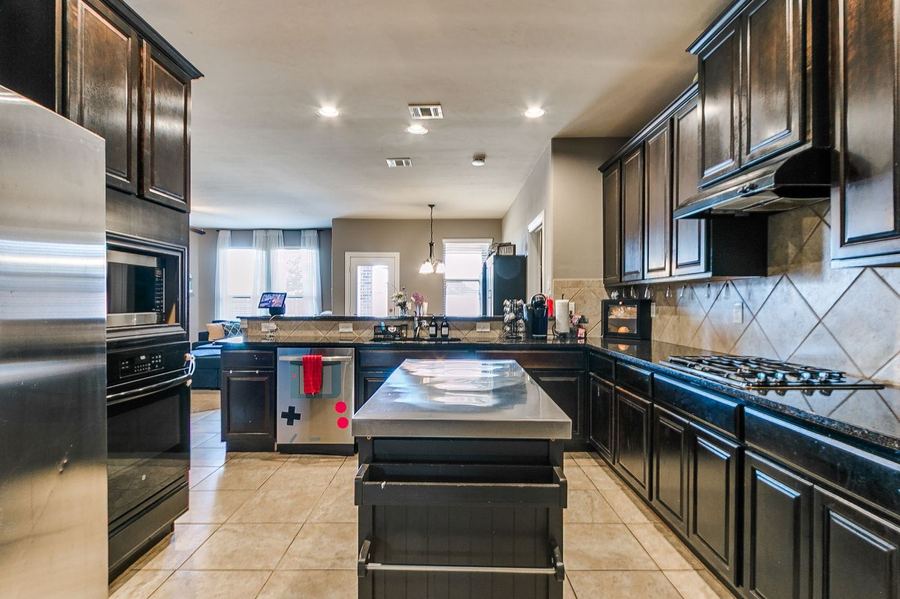 Kitchen with dark cabinets and an island