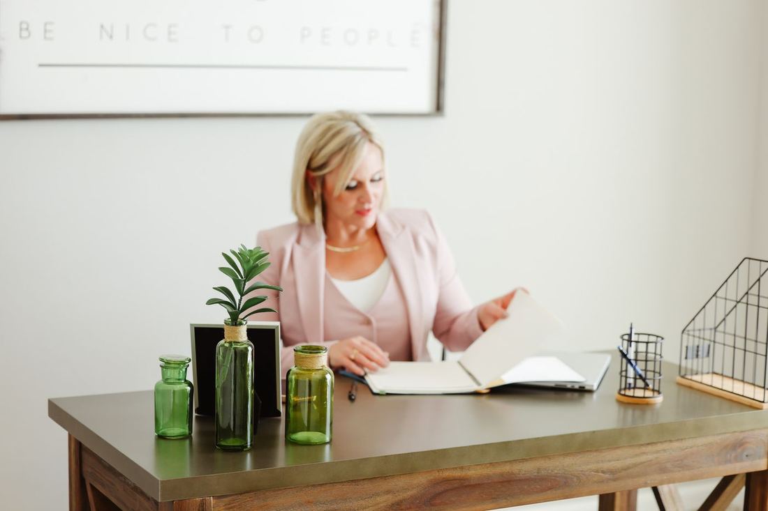Katherine Price reviewing a listing plan at a desk